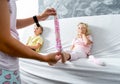 Mom takes off her little daughter`s socks and tickles her feet a little. The girl laughs Royalty Free Stock Photo