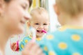 Mom teaches baby brushing teeth Royalty Free Stock Photo