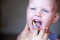 Mom teaches and helps her three-year-old son to brush his teeth Royalty Free Stock Photo