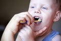 Mom teaches and helps her three-year-old son to brush his teeth Royalty Free Stock Photo