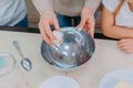 Mom teaches her daughters to cook dough in the kitchen