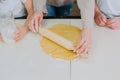 Mom teaches her daughters to cook dough in the kitchen