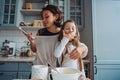 Mom teaches her little daughter to cook food Royalty Free Stock Photo