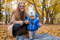 Mom teaches the kid to walk. .Young mother walks in the park with baby. Royalty Free Stock Photo