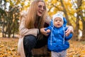 Mom teaches the kid to walk. .Young mother walks in the park with baby. Royalty Free Stock Photo