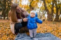Mom teaches the kid to walk. .Young mother walks in the park with baby. Royalty Free Stock Photo