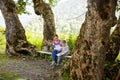 Mom teaches read daughter in campground mountains