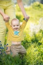 Mom teaches son walking grass