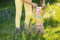 Mom teaches son walking grass