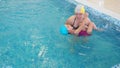 mom teaches to swim a little girl 2 3 years old. Mother and daughter practice swimming in the pool. children's sports