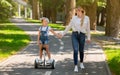 Mom Teaching Little Daughter To Ride Segway In Park