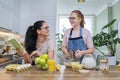 Mom and teen daughter cooking apple pie together at home kitchen Royalty Free Stock Photo