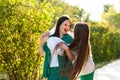 Mom and teenage daughter hugging on walk in park Royalty Free Stock Photo