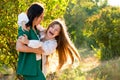 Mom and teenage daughter hugging on walk in park Royalty Free Stock Photo