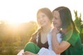 Mom and teenage daughter hugging on walk in park Royalty Free Stock Photo