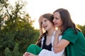 Mom and teenage daughter hugging on walk in park Royalty Free Stock Photo