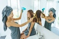 Mom brushing hair to her daughter in hotel bathroom Royalty Free Stock Photo