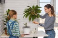 Mom tells her daughter how to properly cut a houseplant for reproduction