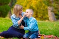 Mom tenderly took her teen`s nose while relaxing in a clearing in a park