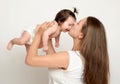 Mom throws baby baby and kiss, play and having fun Royalty Free Stock Photo