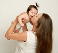 Mom throws baby baby and kiss, play and having fun Royalty Free Stock Photo