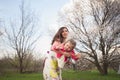 Mom throws daughter plays on the background of blue sky