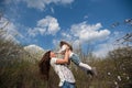 Mom throws daughter plays on the background of blue sky