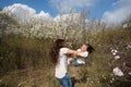 Mom throws daughter plays on the background of blue sky