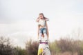 Mom throws daughter plays on the background of blue sky