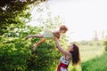 Mom throws daughter plays in sunset ligt Royalty Free Stock Photo