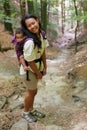 Mom with toddler boy on sandstone path in forest