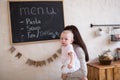 Mom and Toddler Daughter playing menu planning write to blackboard and chalk, Royalty Free Stock Photo