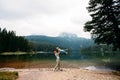 Mom and toddler daughter stand and look at Black Lake, Durmitor, Montenegro. Travel with kids. Family vacation.