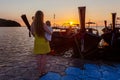 Mom with a toddler enjoys the sunrise standing on the pantone pier. Rear view, from the back Royalty Free Stock Photo