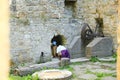 Mom with toddler observing broken iron mill gear in Dolsky mill