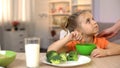 Mom touching girl who eating healthy breakfast, vegetarian lifestyle, broccoli