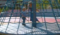 Mom turns the baby on the carousel