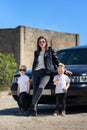 Mom and the twins in leather jackets and sunglasses.A bold and cool family image