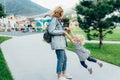 Mom twirls her daughter holding her hands, mom plays with her daughter. Royalty Free Stock Photo