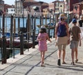 mom and two children walking on the island of Murano near Venice