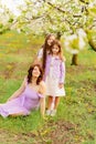 mom and two daughters. A family in a blossoming spring garden. Royalty Free Stock Photo