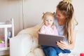 Mom using tablet together with her kid Royalty Free Stock Photo