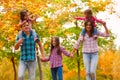 Mom walk with kids in the autumn maple forest Royalty Free Stock Photo