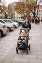 Mom walking with with baby in pram. Young mother with baby girl Royalty Free Stock Photo