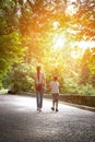 Mom walking with her son in the Park. Single mother. Nanny and the child. Siblings. Vertical frame
