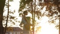 Mom walks with her daughter on her shoulders under the trees. mother carries on her shoulders her beloved child, in park Royalty Free Stock Photo