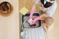 Mom washes dishes, while the son put the car in the sink Royalty Free Stock Photo