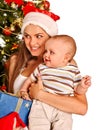 Mom wearing Santa hat holding baby under Royalty Free Stock Photo