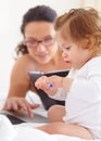 Mom, working and multitasking on laptop with baby in home for remote work or writing project. Infant, kid and mother Royalty Free Stock Photo