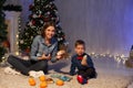 Mom and young boy open Christmas presents Christmas tree new year holiday Royalty Free Stock Photo